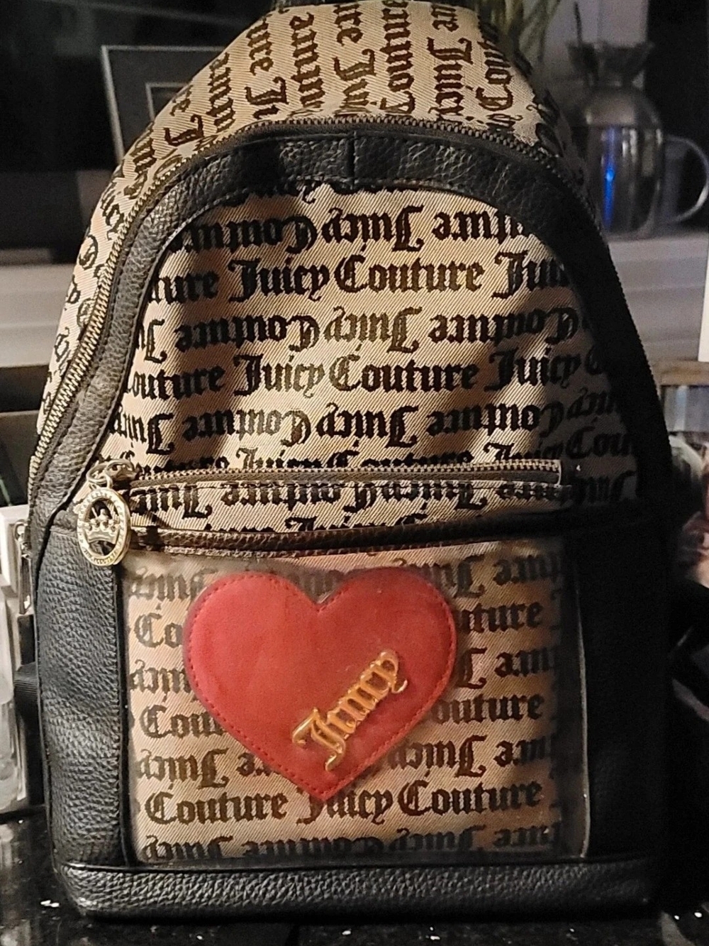 Juicy Couture "Cross My Heart" mini backpack in a beige and black logo print